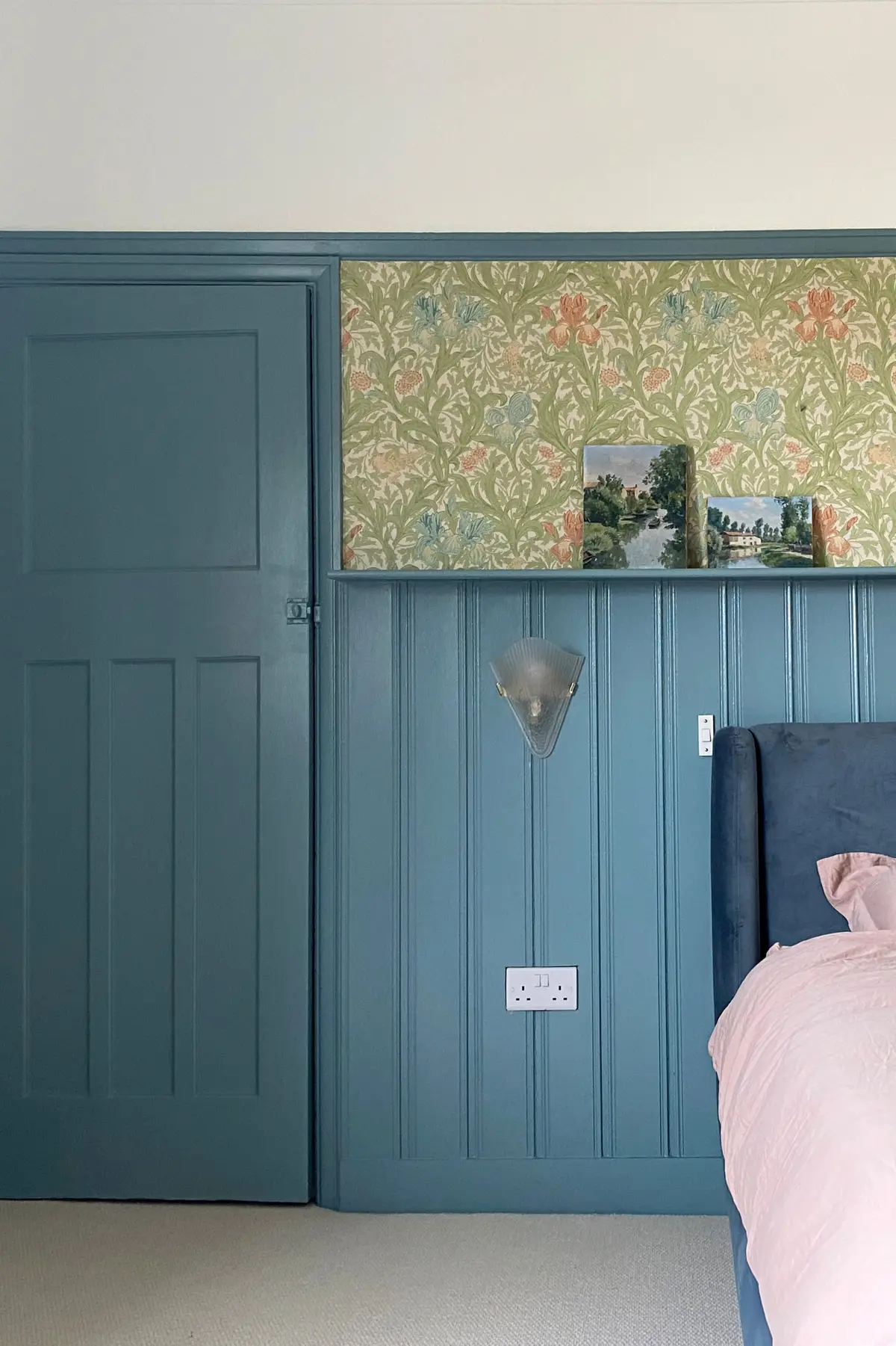 Bedroom with teal tongue-and-groove panelling and a Morris-pattern wallpaper