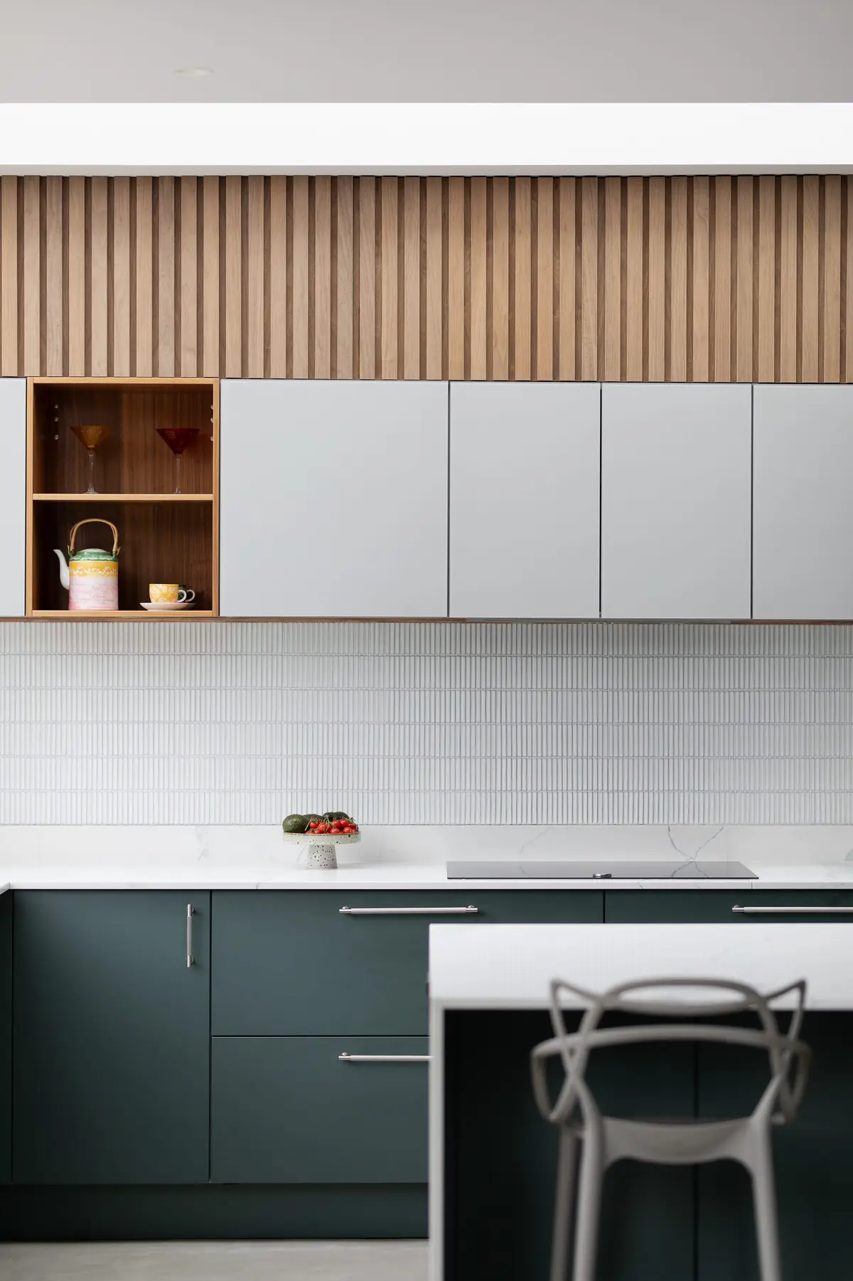 Kitchen with white tiled splashback, open oak cubbies and white cabinets