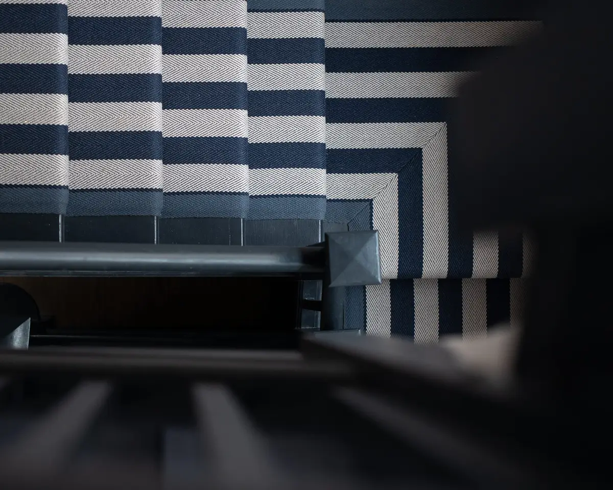 Staircase wrapped in bold navy-and-white stripes