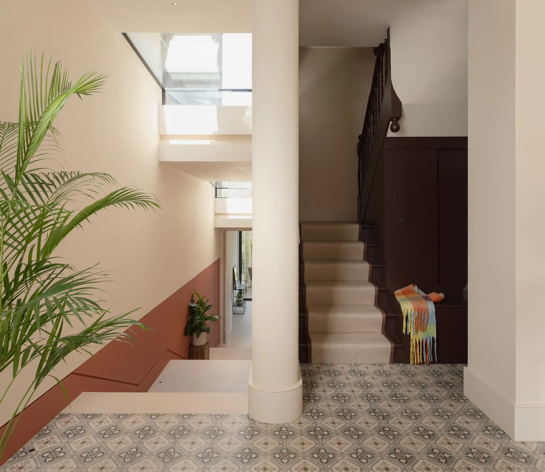 Light-filled hallway with plants leading to the staircase, Crouch End