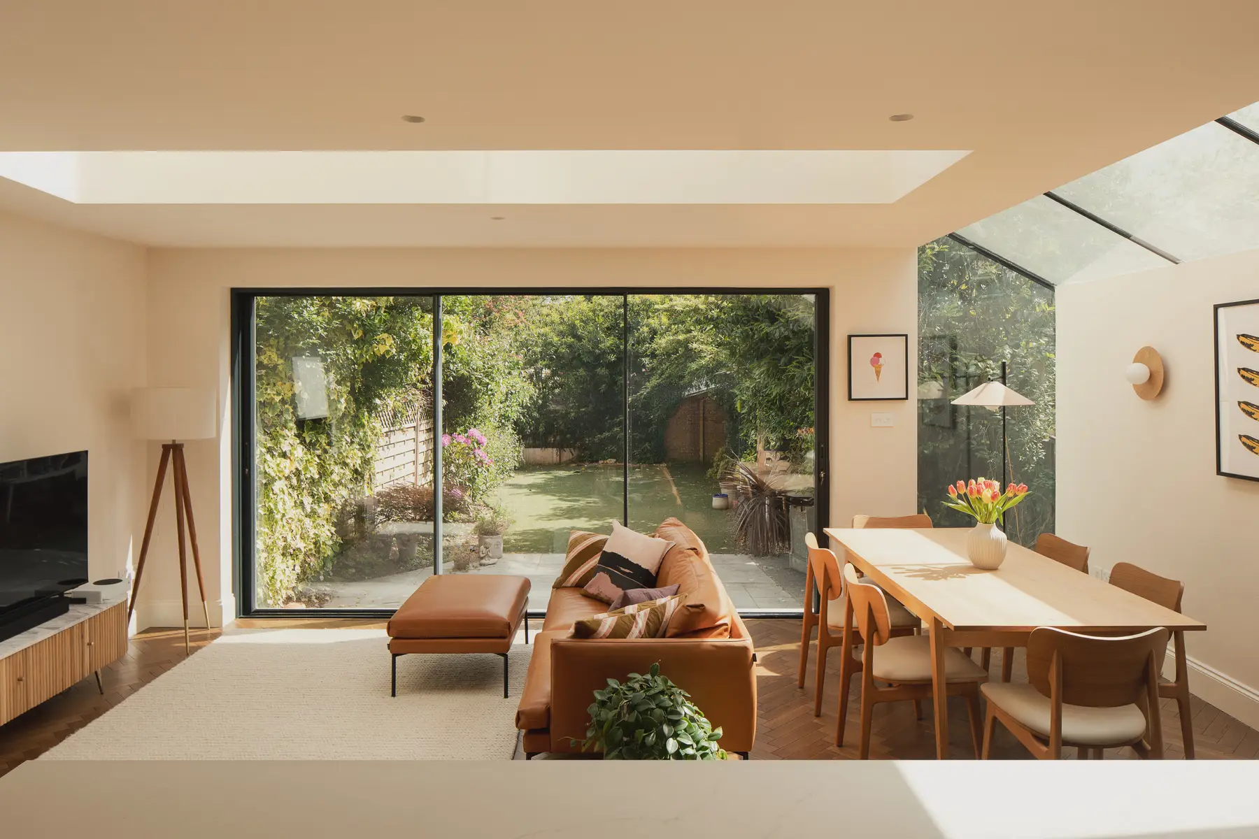 Open-plan living and dining space with glazed doors onto the garden
