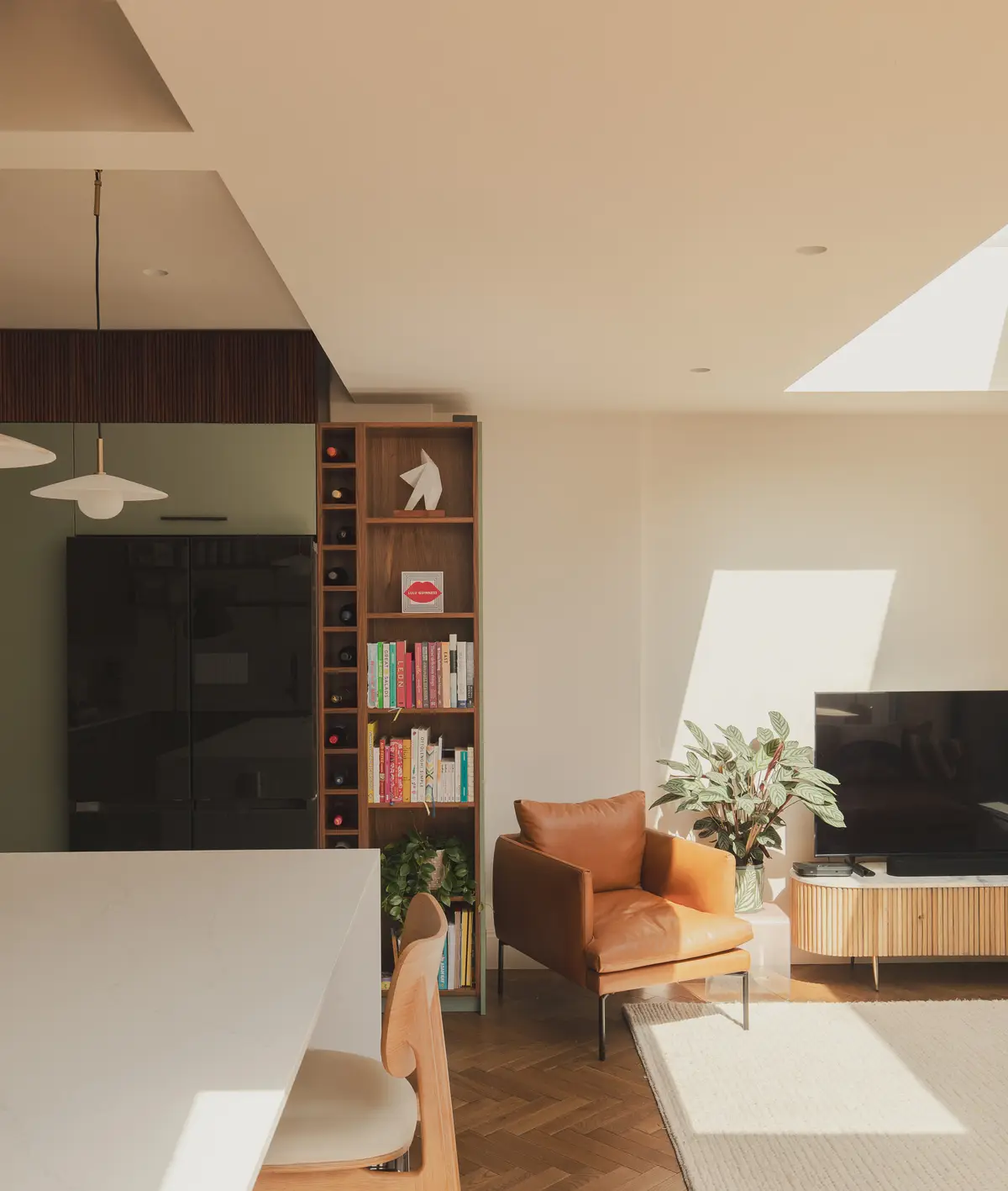 Snug with built-in bookshelves, a tan armchair and a wood-burning stove