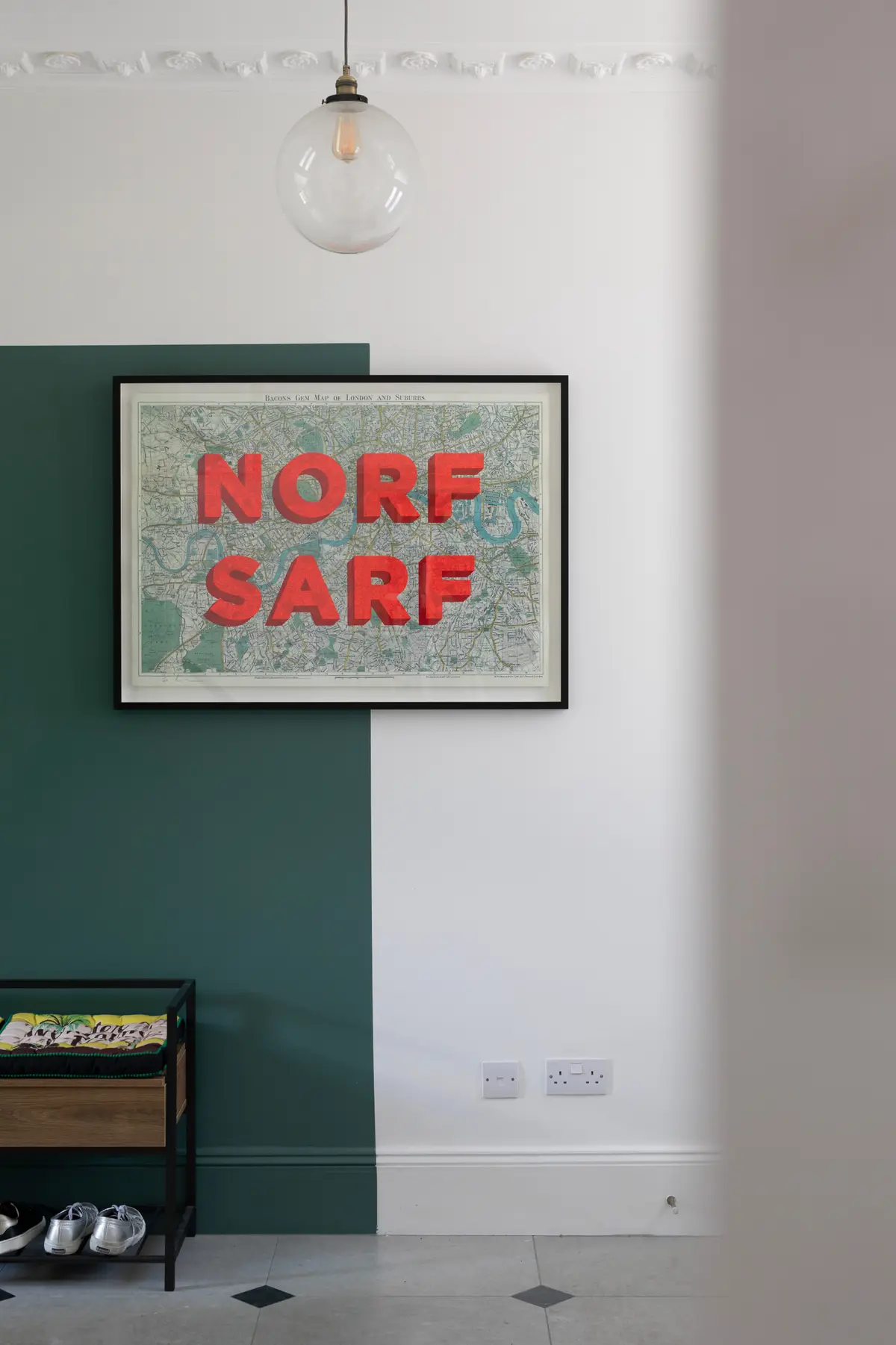 Typographic London print on a dark green and white wall