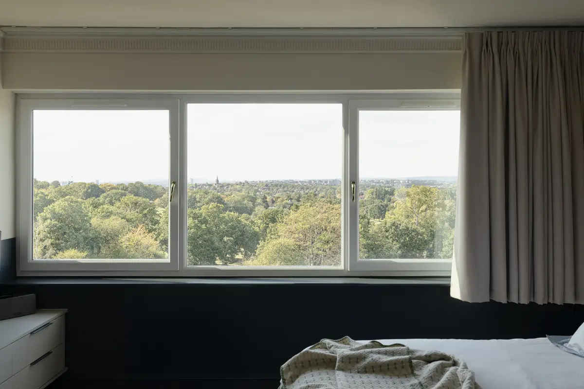 Bedroom window framing the green view across the golf course