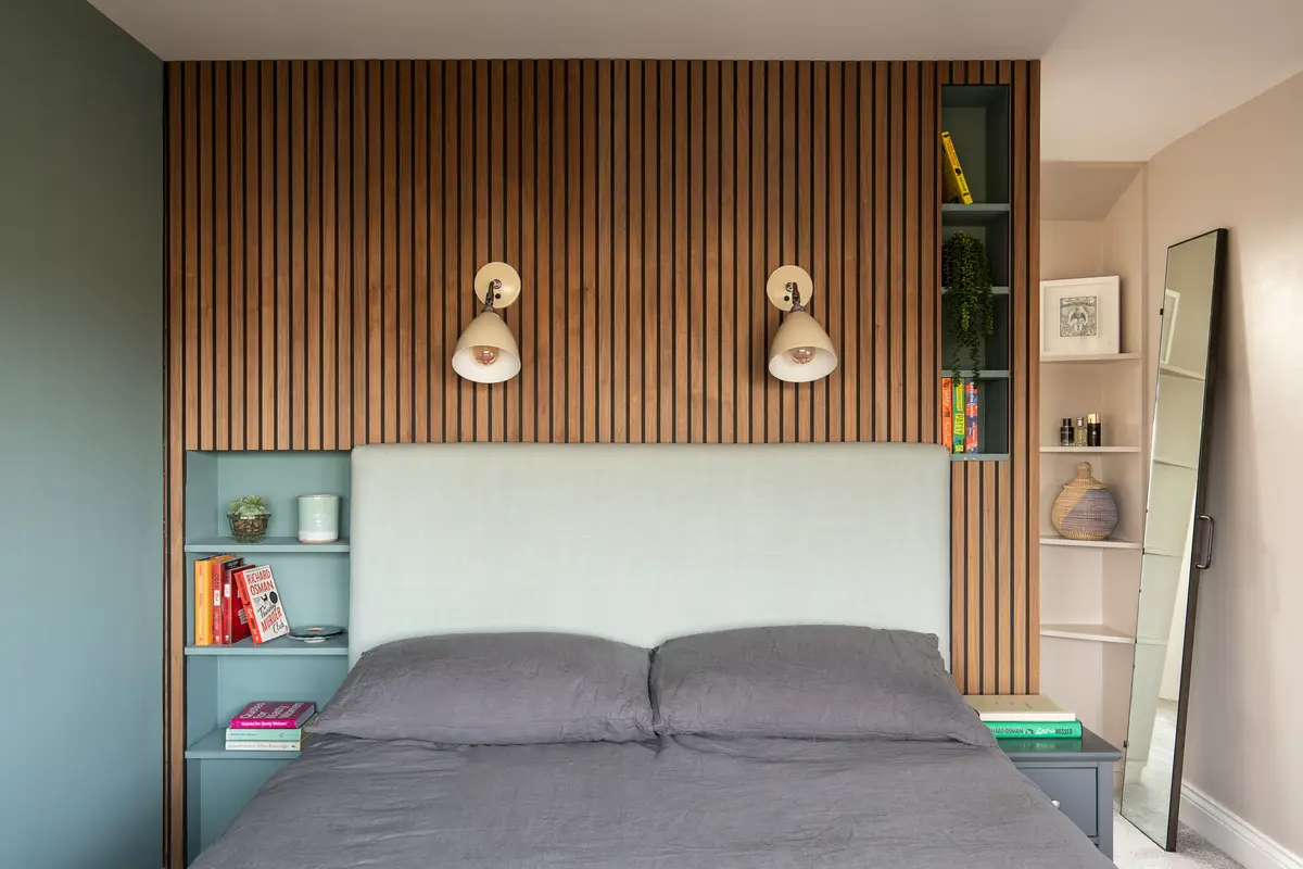 Bedroom with an oak slatted headboard wall and built-in shelving, Finsbury Park